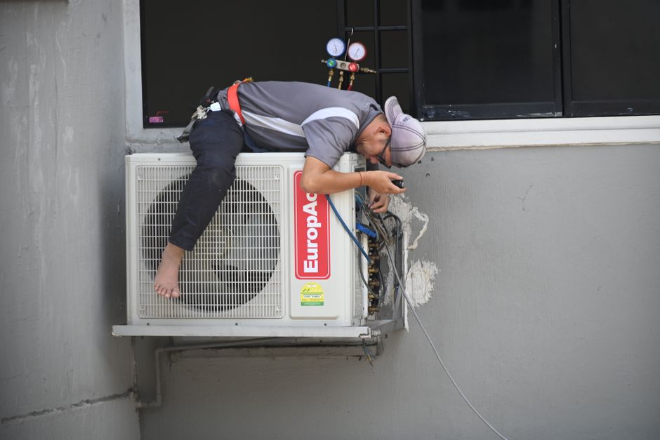 Air conditioning technician performing maintenance